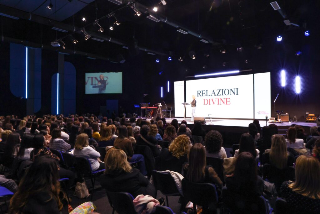 Carrie Pasch speaking at the Relazioni Divine conference in Italy